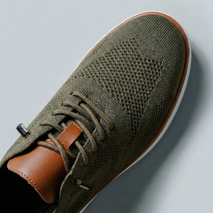 The Cottesloe knit sneaker — close-up of genuine leather heel, eyelets and tongue patch
